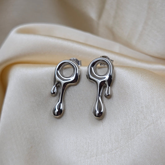 Art-inspired rodium studs with a melted liquid metal form, offering a bold yet elegant statement style for everyday and special occasions.