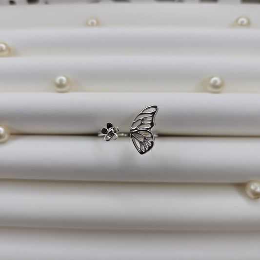 Butterfly wing and flower open band ring in polished rhodium finish, offering a lightweight and artistic everyday statement look.