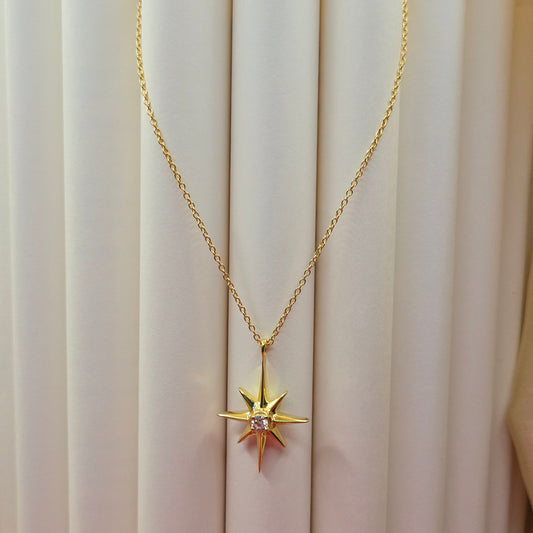 Gold-plated chain necklace featuring an eight-point starburst pendant with a clear faceted crystal at the center, offering a celestial and minimal everyday style