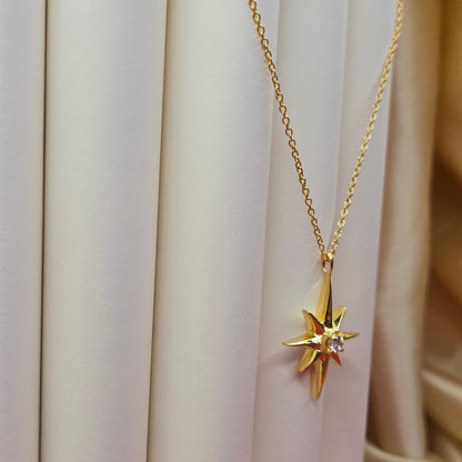 Gold-plated chain necklace featuring an eight-point starburst pendant with a clear faceted crystal at the center, offering a celestial and minimal everyday style