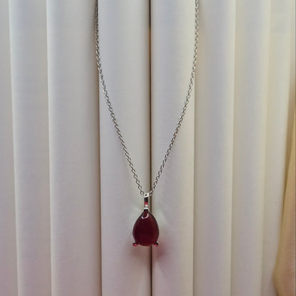 Rhodium plated chain necklace featuring a smooth teardrop-shaped deep maroon gemstone pendant, styled against a soft neutral backdrop for an elegant and minimal look.