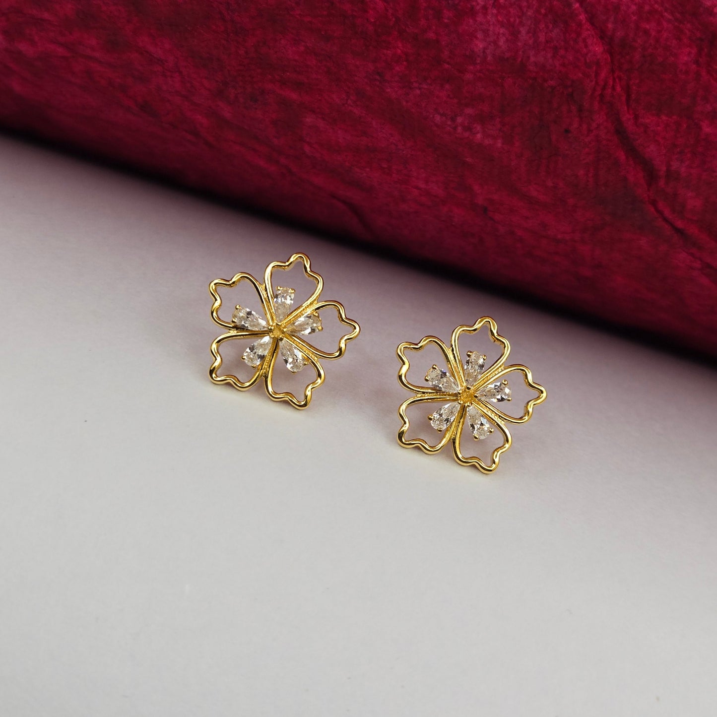 Gold-plated flower studs with shimmering crystal petals arranged in a symmetrical bloom design, suitable for both casual and festive styling
