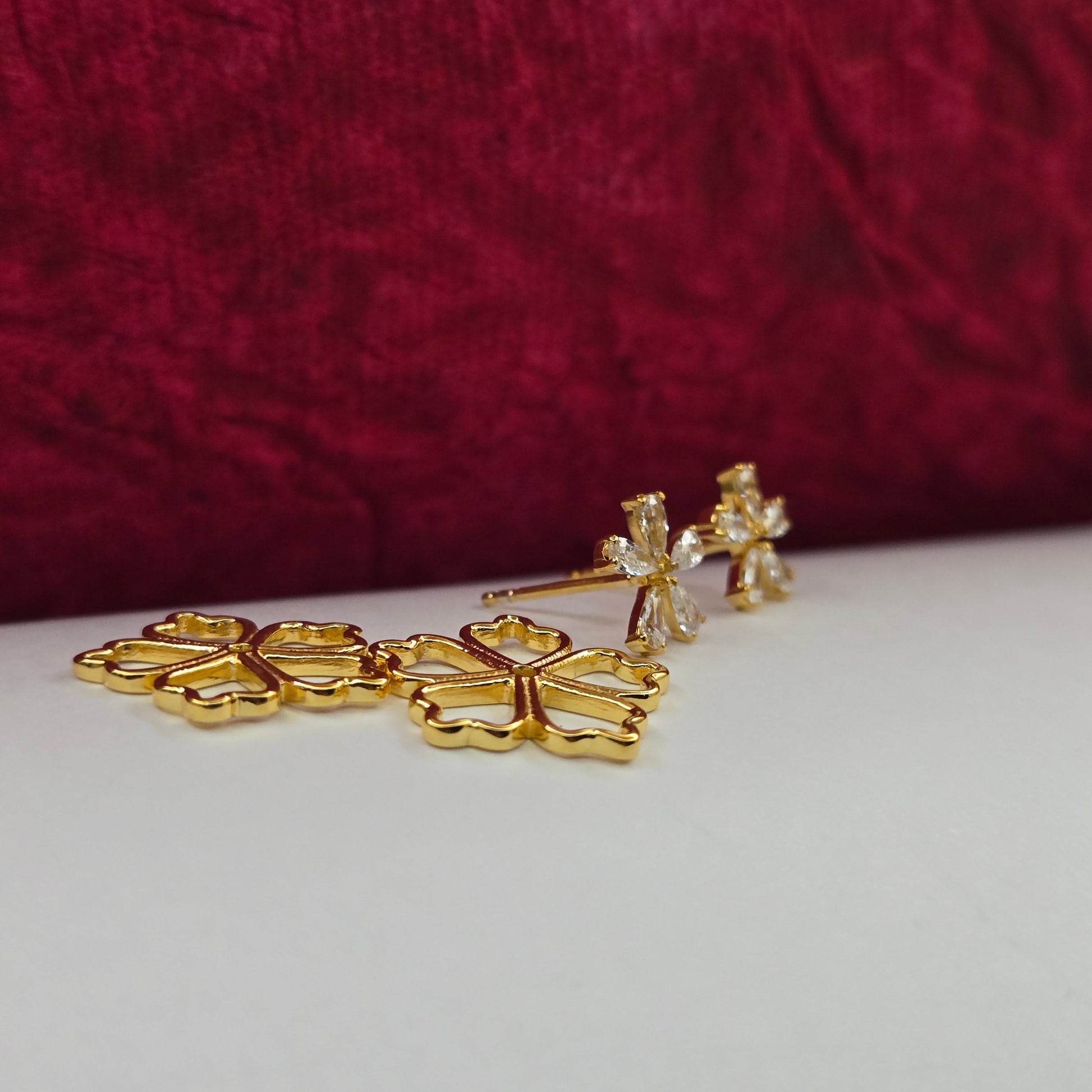 Gold-plated flower studs with shimmering crystal petals arranged in a symmetrical bloom design, suitable for both casual and festive styling