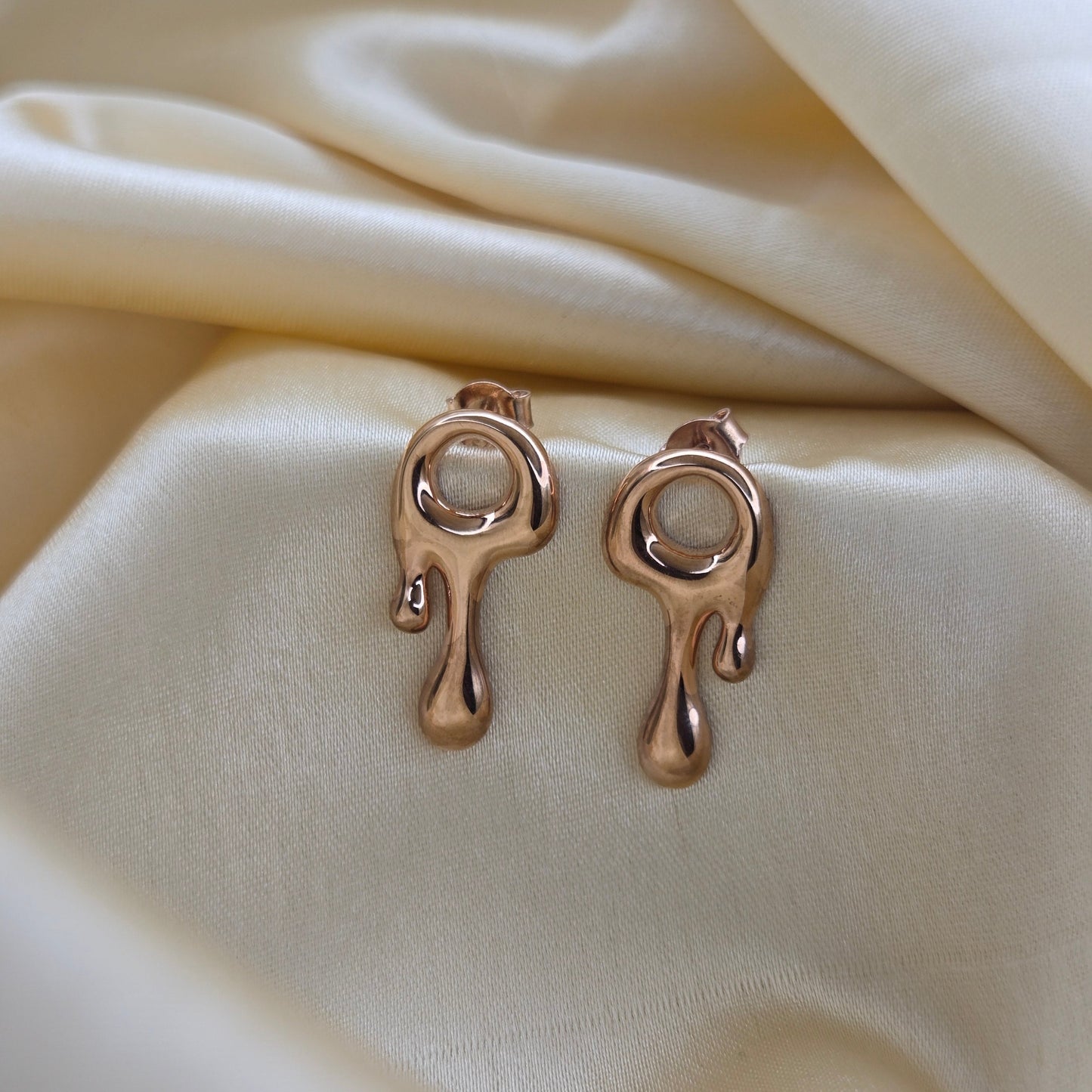 Art-inspired Rose-gold studs with a melted liquid metal form, offering bold yet elegant statement style for everyday and occasion wear.