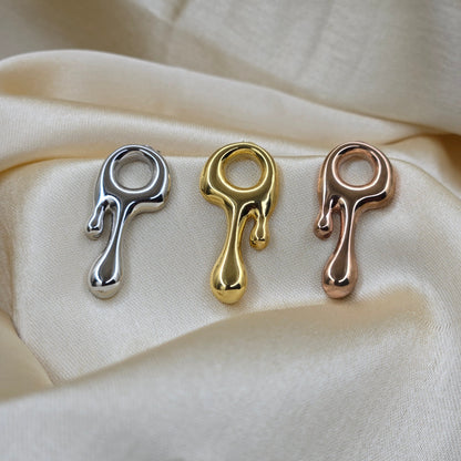 Art-inspired gold, rose-gold & rhodium studs with a melted liquid metal form, offering bold yet elegant statement style for everyday and occasion wear.