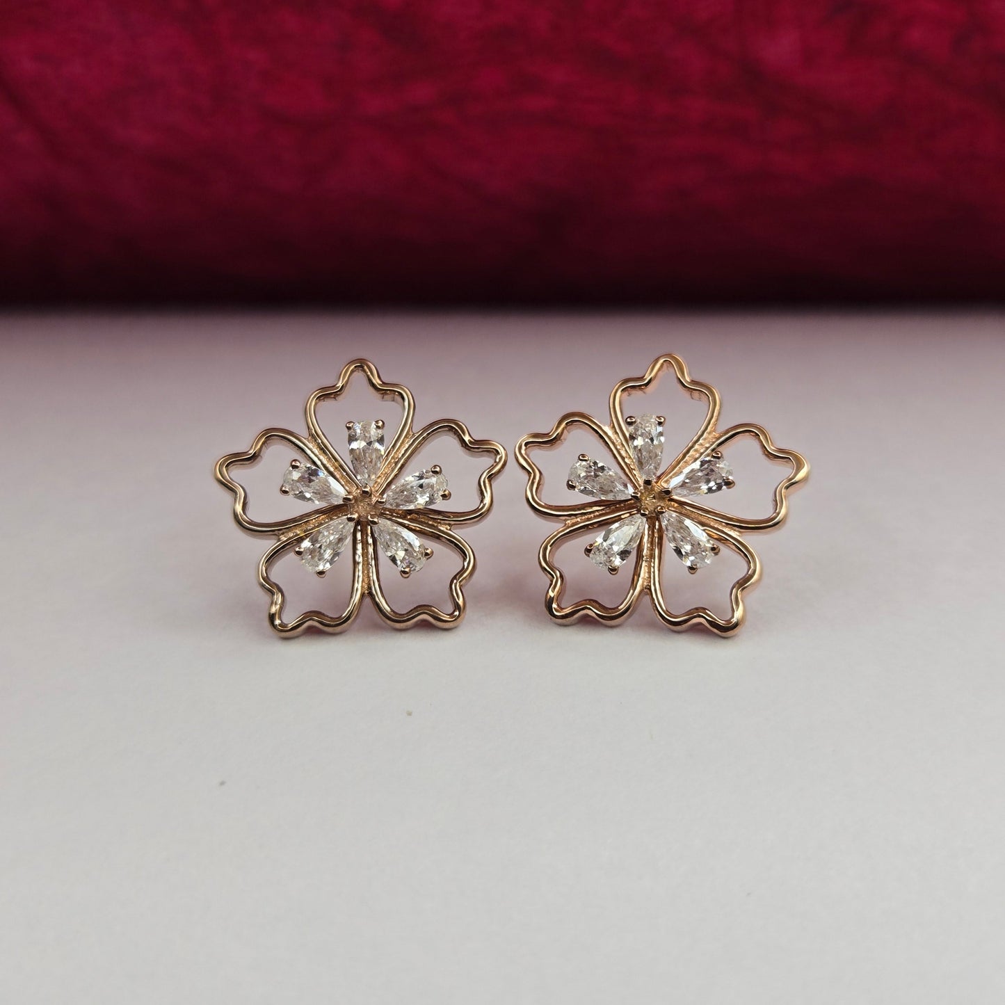 Rose-gold plated flower studs with shimmering crystal petals arranged in a symmetrical bloom design, suitable for both casual and festive styling