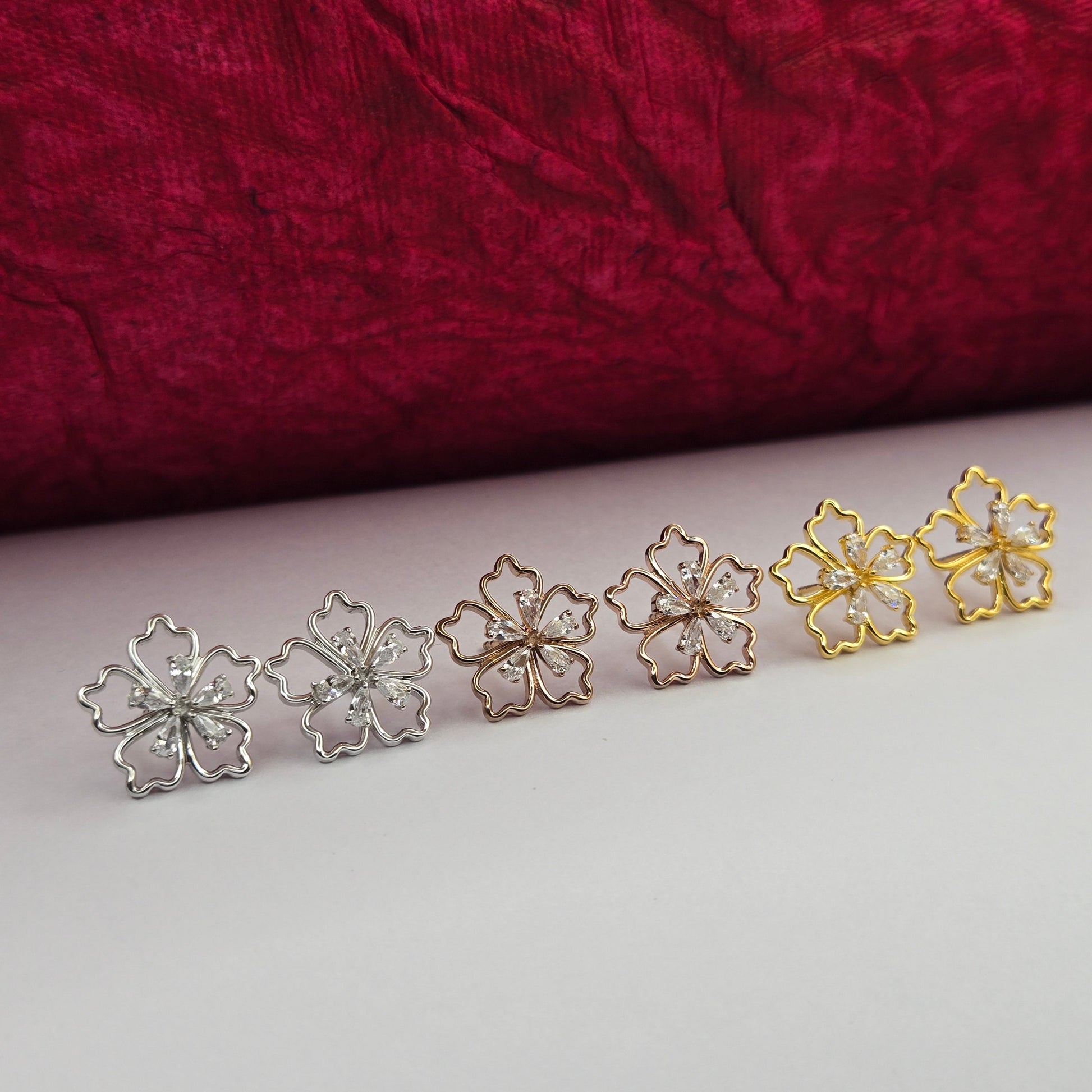 Gold, Rhodium and Rose-gold plated flower studs with shimmering crystal petals arranged in a symmetrical bloom design, suitable for both casual and festive styling