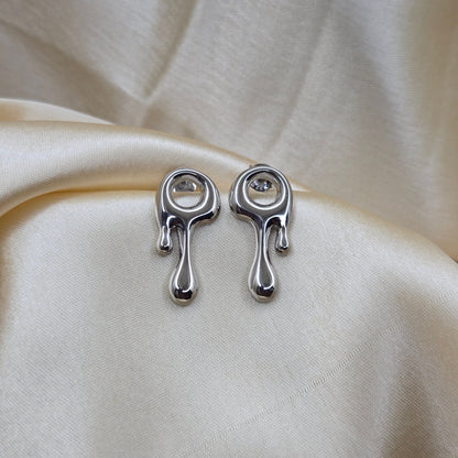 Art-inspired rodium studs with a melted liquid metal form, offering a bold yet elegant statement style for everyday and special occasions.