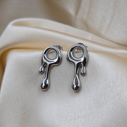 Art-inspired rodium studs with a melted liquid metal form, offering a bold yet elegant statement style for everyday and special occasions.