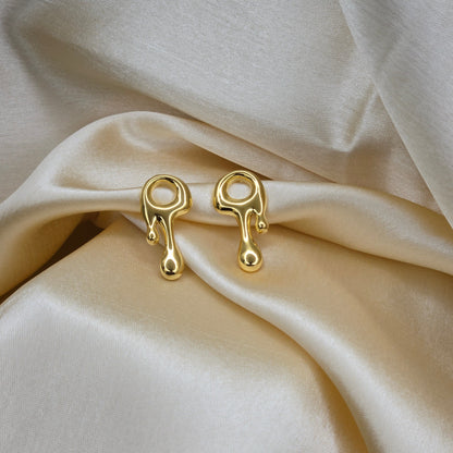 Art-inspired gold studs with a melted liquid metal form, offering a bold yet elegant statement style for everyday and special occasions.