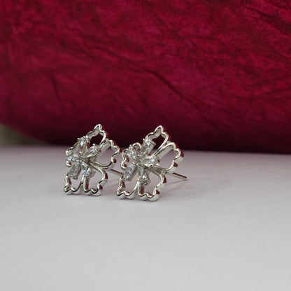 Rhodium-plated flower studs with shimmering crystal petals arranged in a symmetrical bloom design, suitable for both casual and festive styling