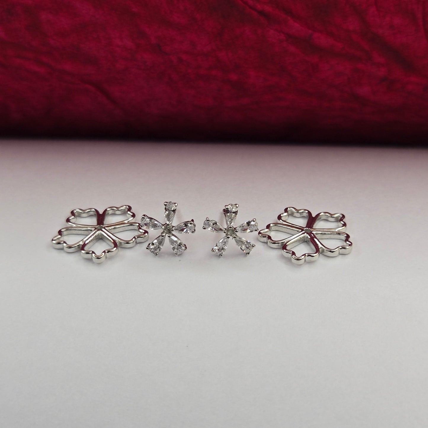 Rhodium-plated flower studs with shimmering crystal petals arranged in a symmetrical bloom design, suitable for both casual and festive styling