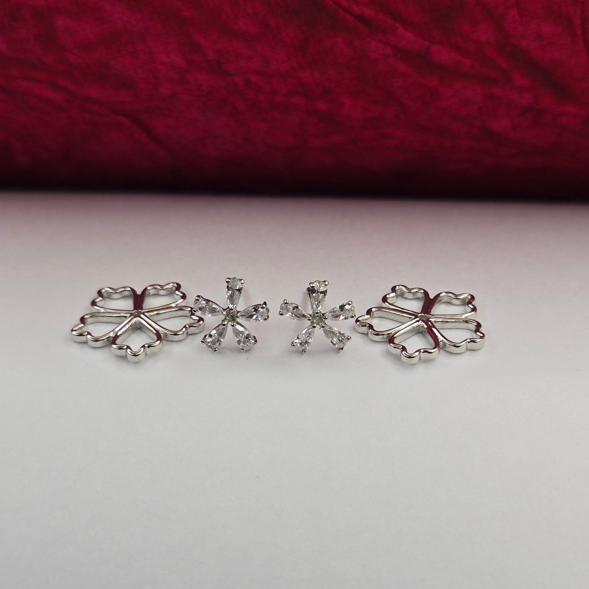 Rhodium-plated flower studs with shimmering crystal petals arranged in a symmetrical bloom design, suitable for both casual and festive styling