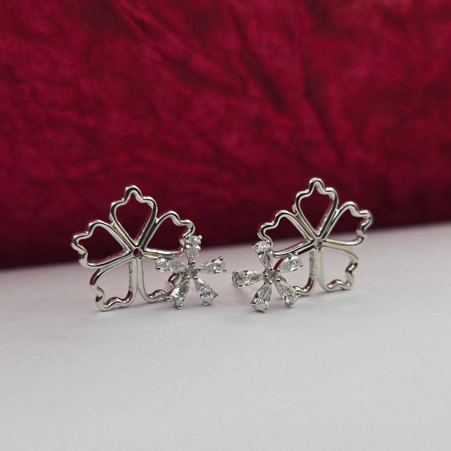 Rhodium-plated flower studs with shimmering crystal petals arranged in a symmetrical bloom design, suitable for both casual and festive styling