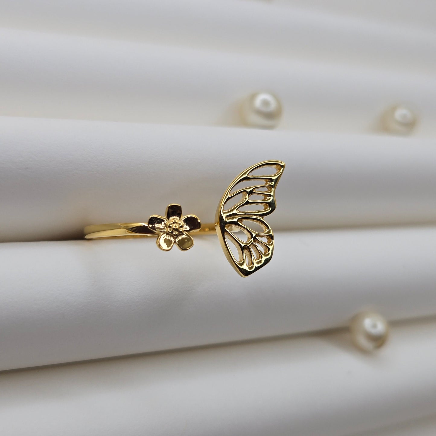 Butterfly wing and flower open band ring in polished gold finish, offering a lightweight and artistic everyday statement look.