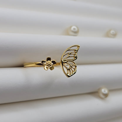 Butterfly wing and flower open band ring in polished gold finish, offering a lightweight and artistic everyday statement look.
