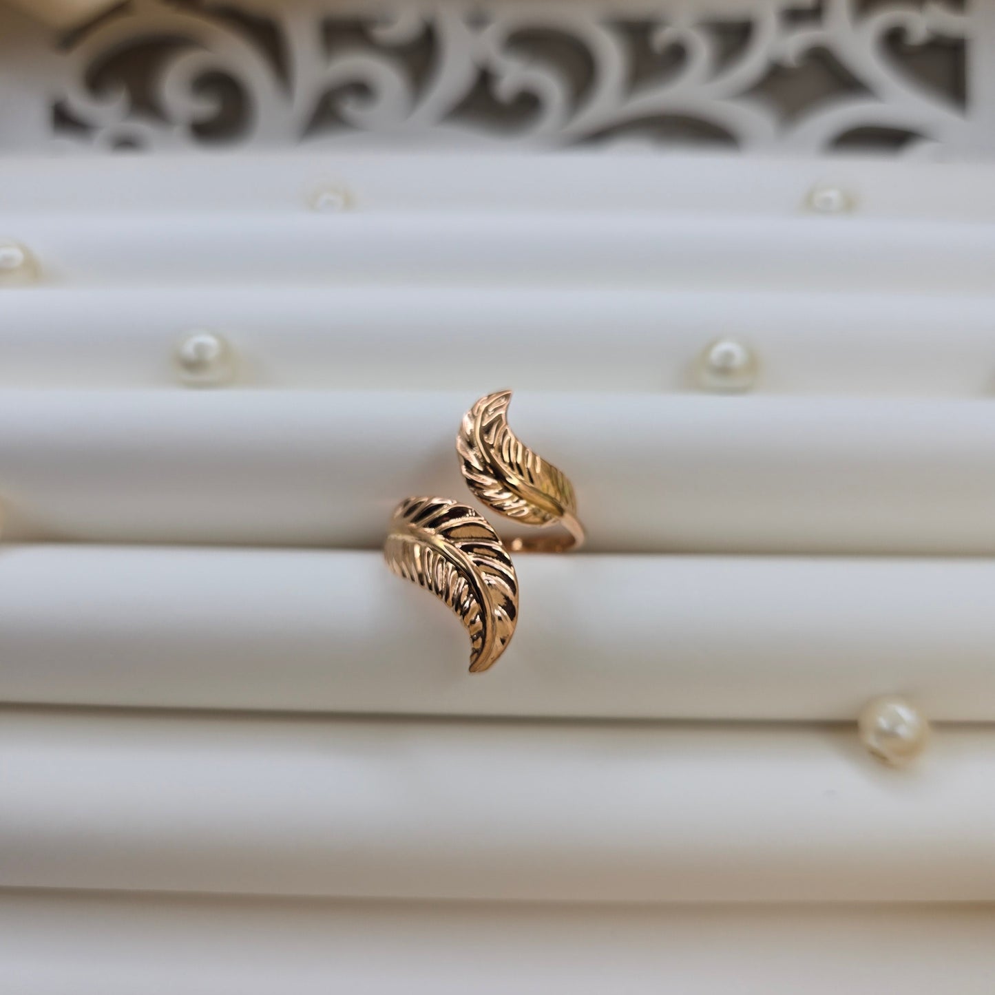 Elegant botanical-inspired ring with twin leaf accents, adjustable fit, and a polished rose-gold tone, perfect for daily wear or stacking.
