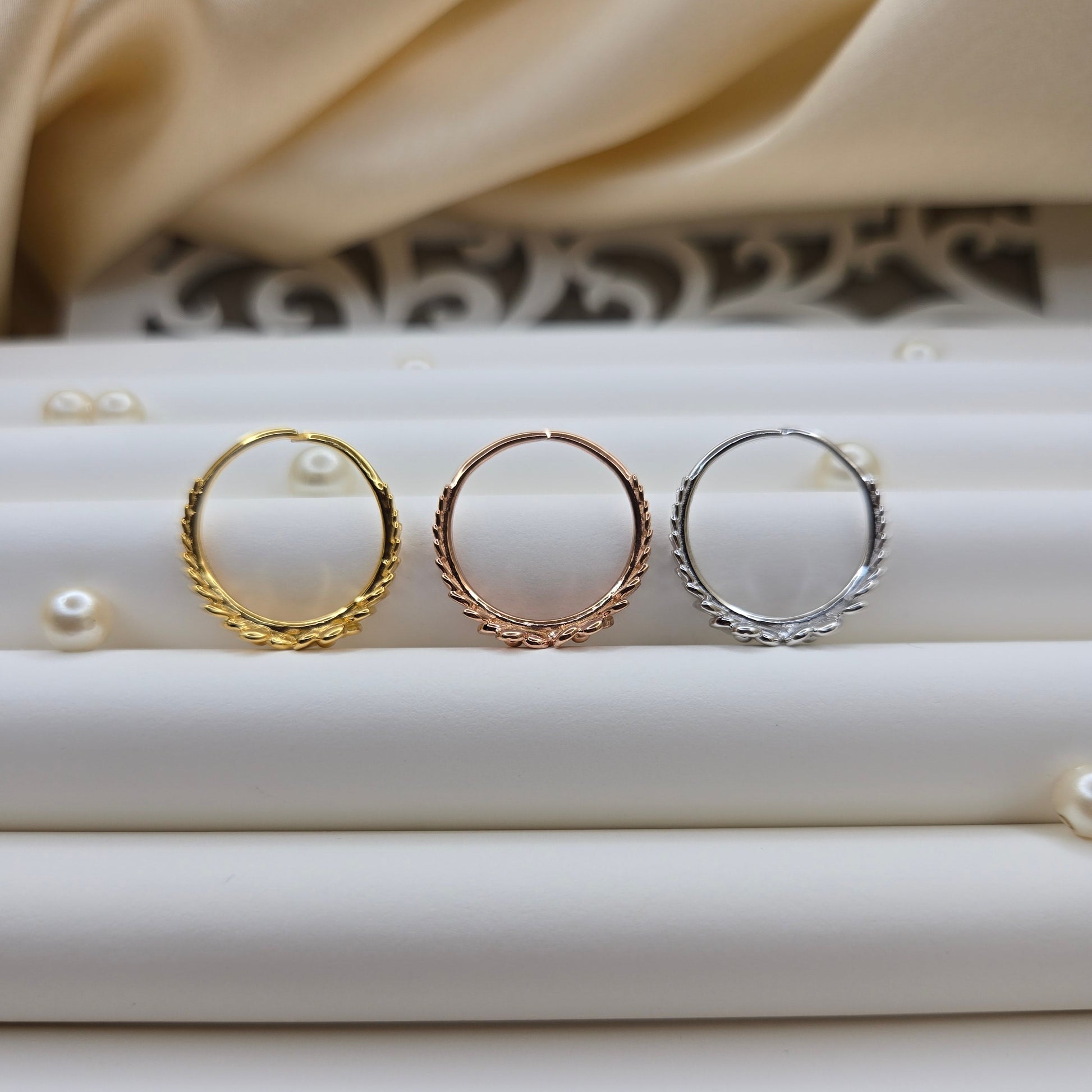 Minimalistic rose gold, gold and rhodium tone flower band ring with smooth petal detailing, perfect for stacking or wearing as a subtle statement piece.