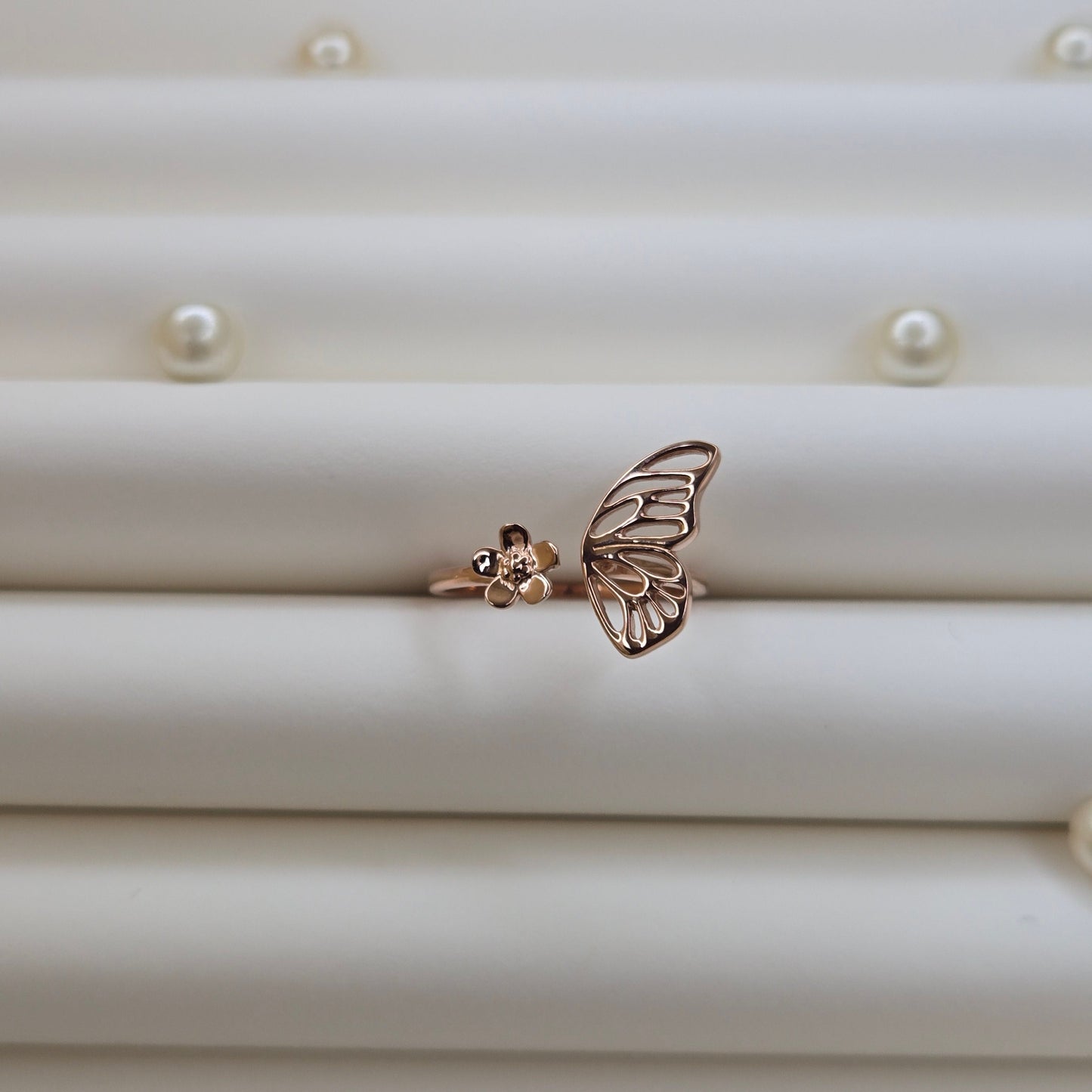 Butterfly wing and flower open band ring in polished rose-gold finish, offering a lightweight and artistic everyday statement look.