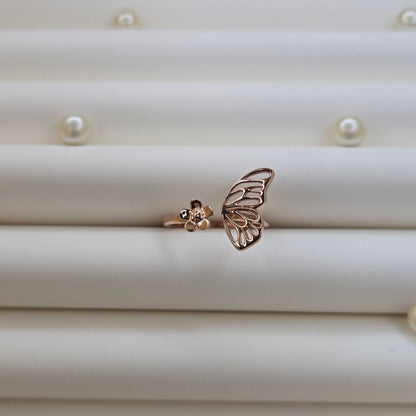 Butterfly wing and flower open band ring in polished rose-gold finish, offering a lightweight and artistic everyday statement look.