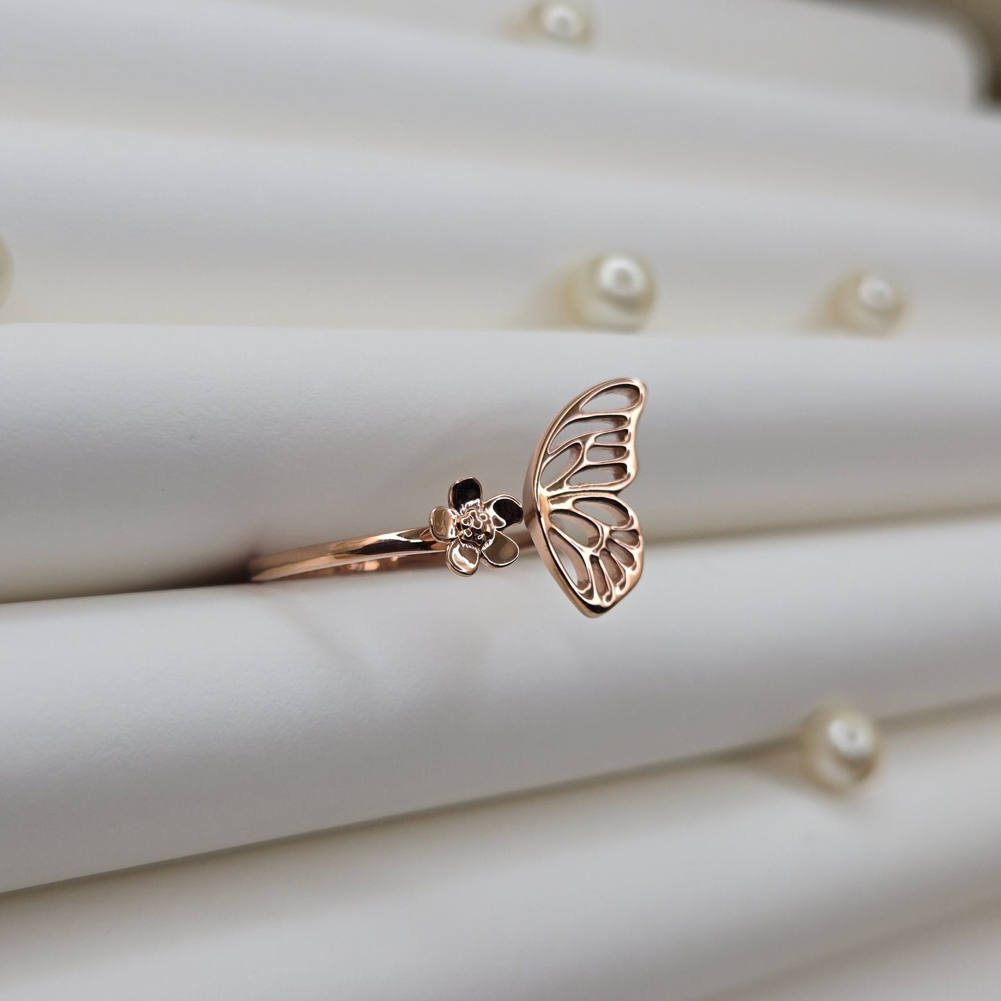 Butterfly wing and flower open band ring in polished rose-gold finish, offering a lightweight and artistic everyday statement look.