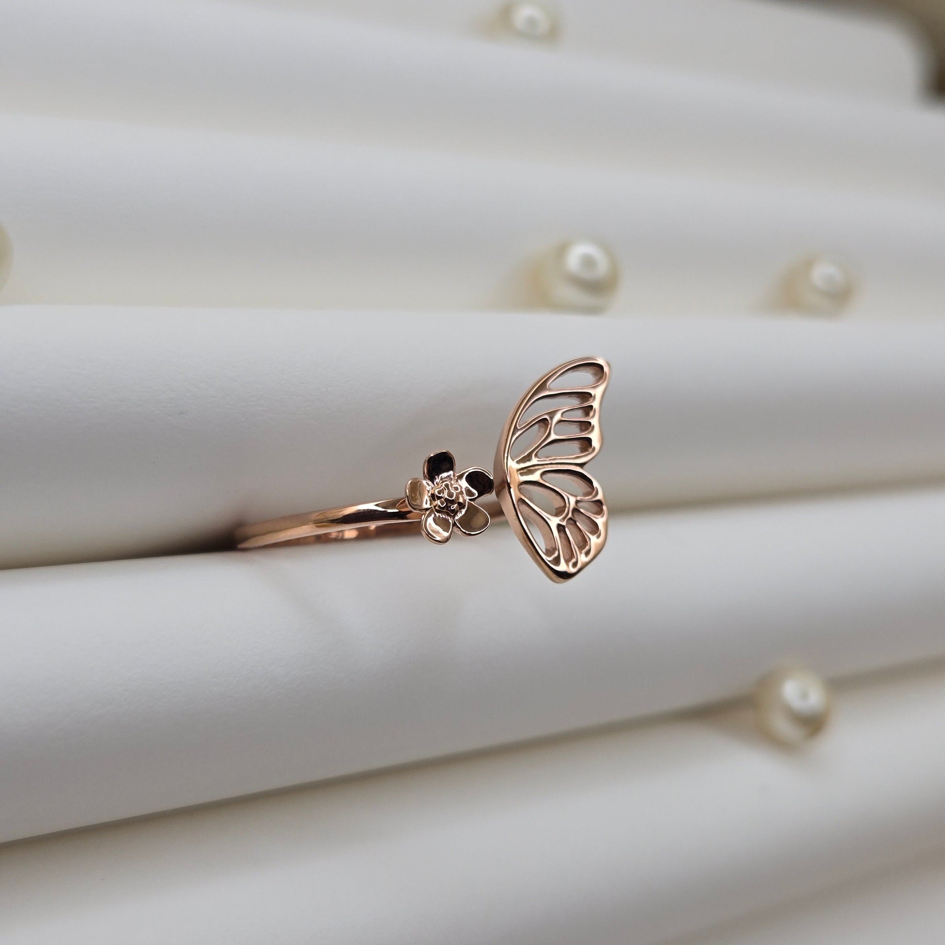 Butterfly wing and flower open band ring in polished rose-gold finish, offering a lightweight and artistic everyday statement look.