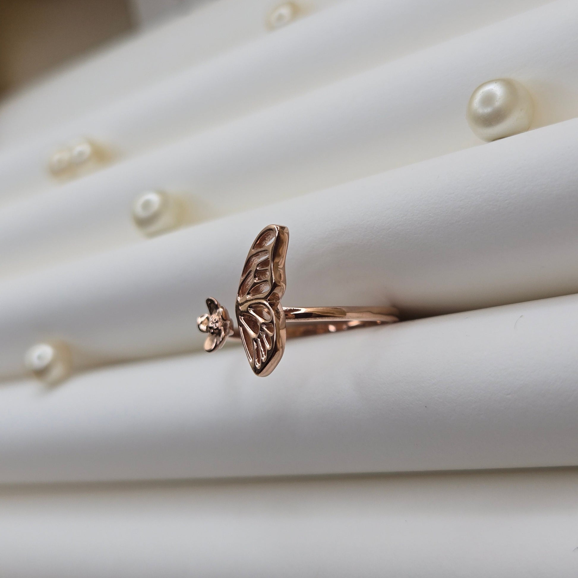 Butterfly wing and flower open band ring in polished rose-gold finish, offering a lightweight and artistic everyday statement look.
