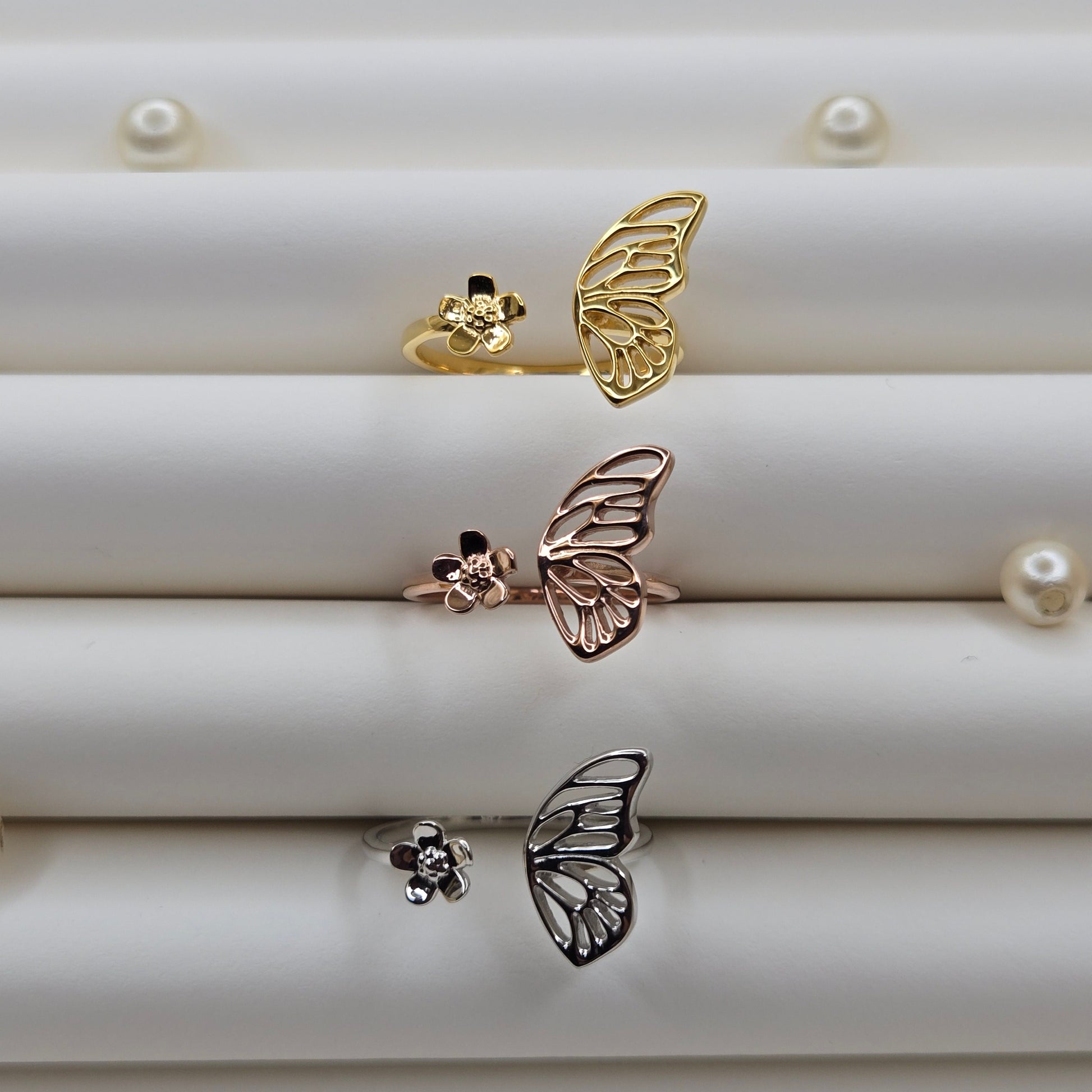 Butterfly wing and flower open band ring in polished gold, rose-gold and rhodium finish, offering a lightweight and artistic everyday statement look.
