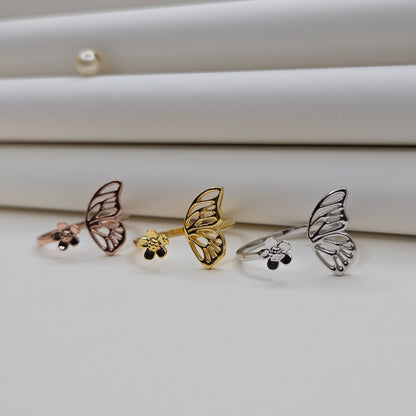 Butterfly wing and flower open band ring in polished gold, rose-gold and rhodium finish, offering a lightweight and artistic everyday statement look.