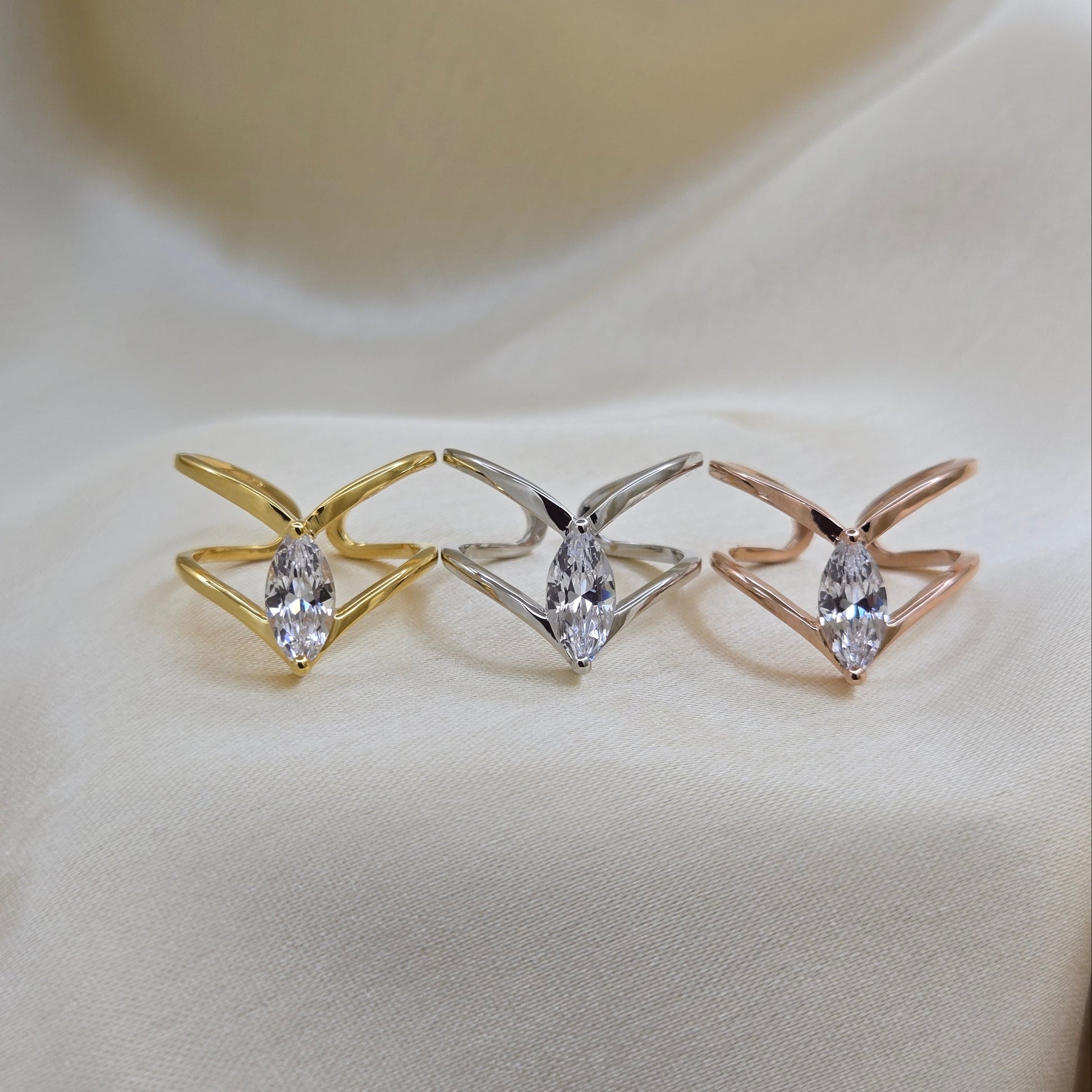 Rhodium, gold and rose-gold plated open band ring with a modern double-band design, featuring a marquise-cut clear zircon stone at the center offering refined sophistication for daily wear or special occasions.