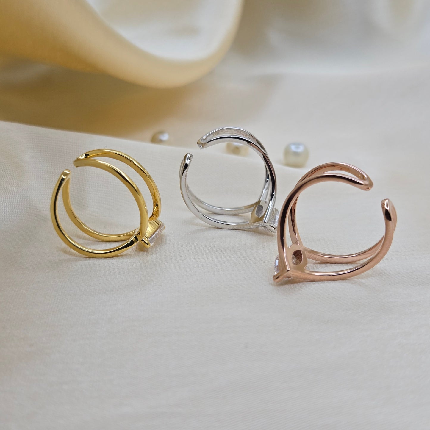 Rhodium, gold and rose-gold plated open band ring with a modern double-band design, featuring a marquise-cut clear zircon stone at the center offering refined sophistication for daily wear or special occasions.