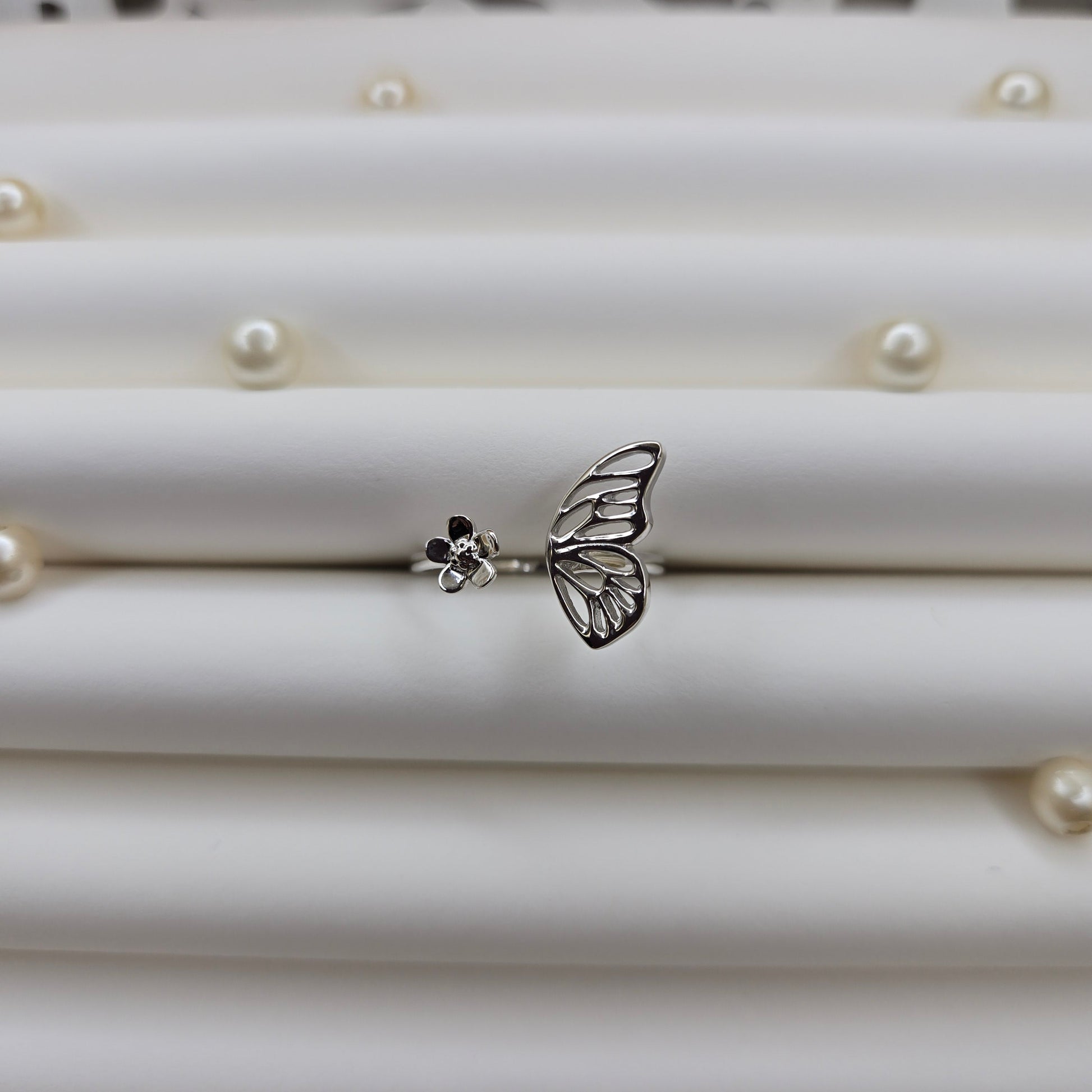 Butterfly wing and flower open band ring in polished rhodium finish, offering a lightweight and artistic everyday statement look.