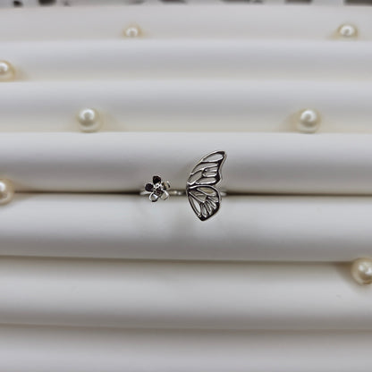 Butterfly wing and flower open band ring in polished rhodium finish, offering a lightweight and artistic everyday statement look.