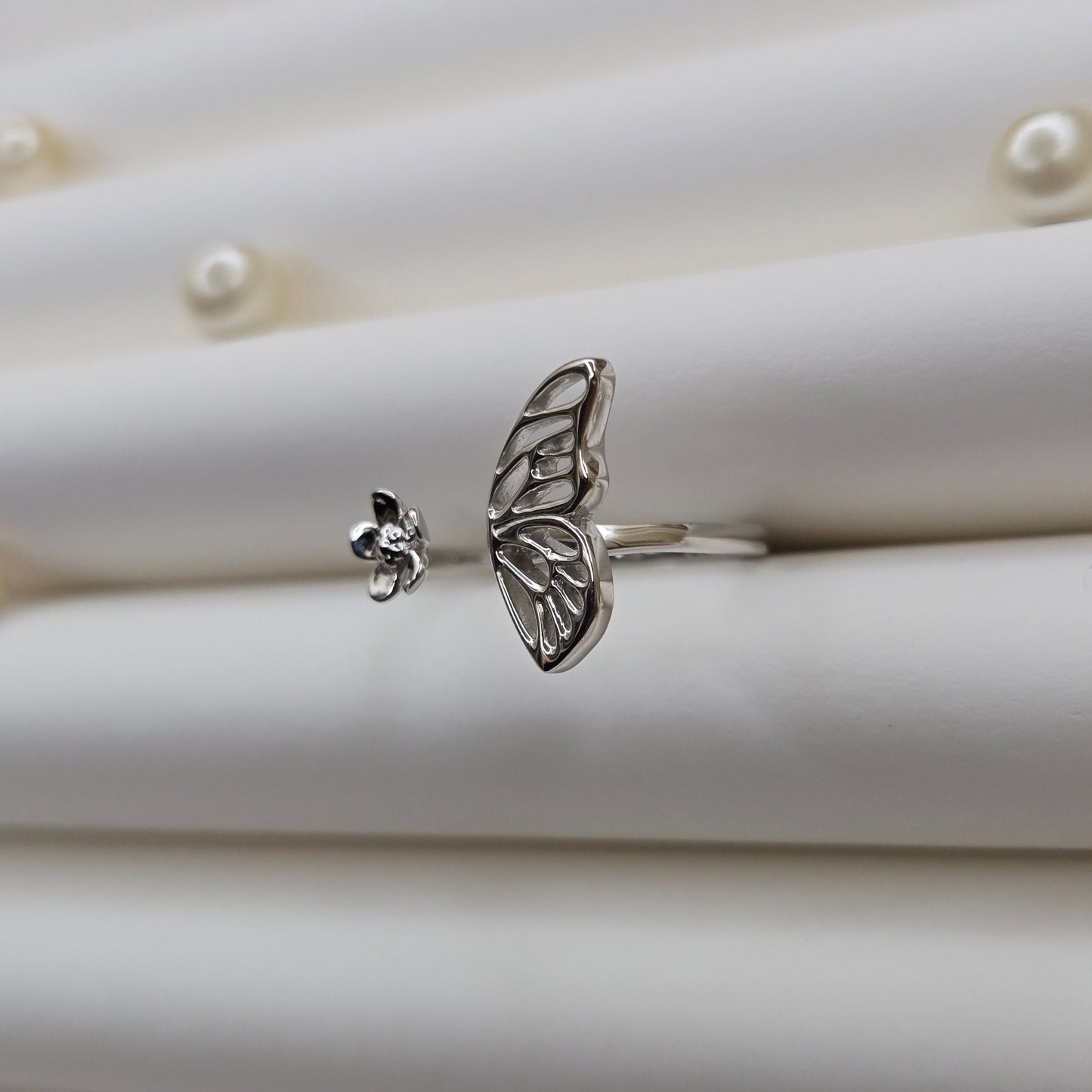 Butterfly wing and flower open band ring in polished rhodium finish, offering a lightweight and artistic everyday statement look.