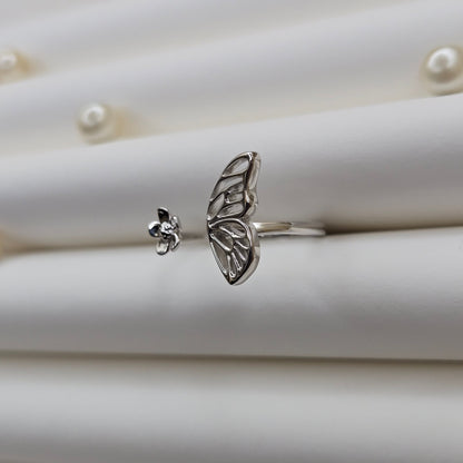 Butterfly wing and flower open band ring in polished rhodium finish, offering a lightweight and artistic everyday statement look.