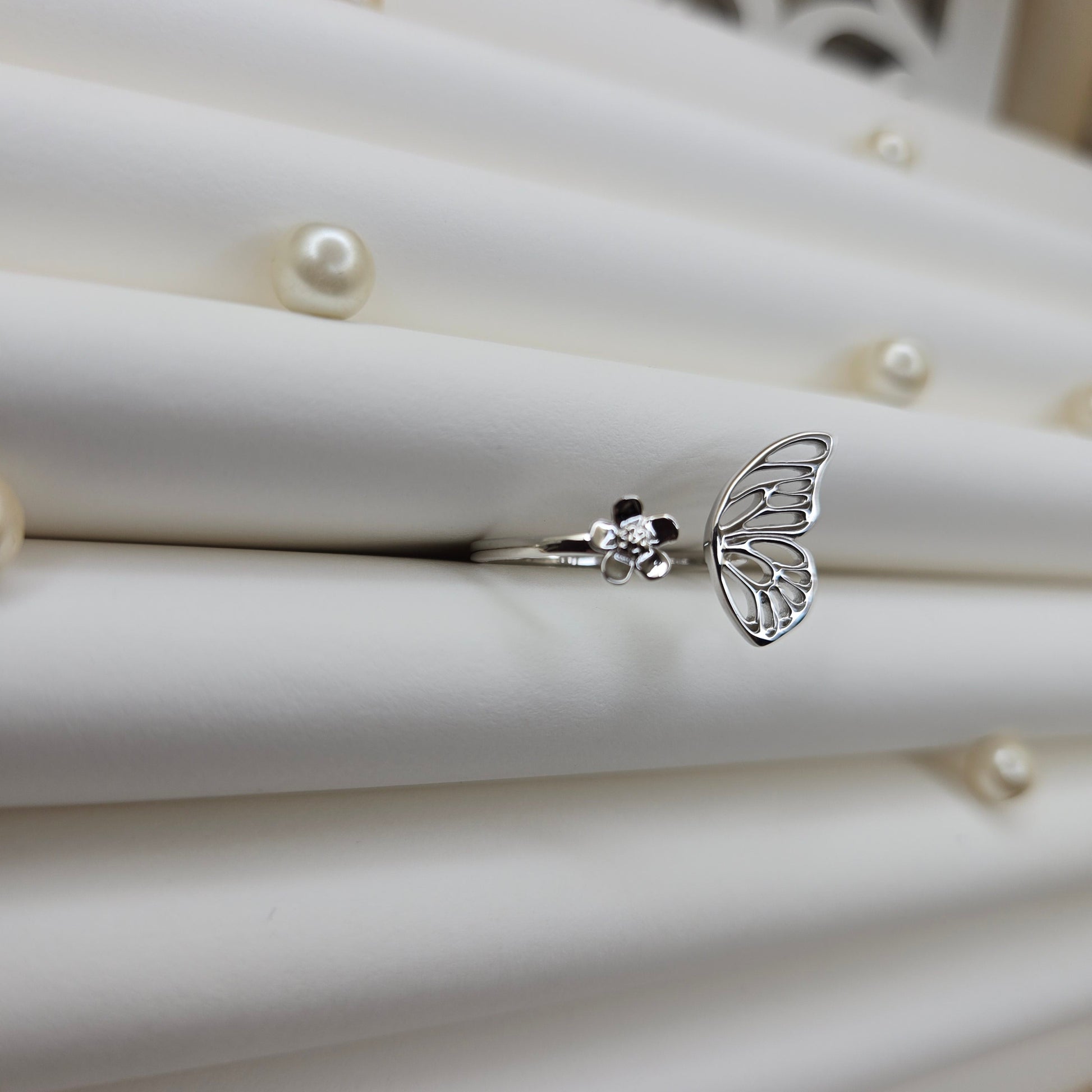 Butterfly wing and flower open band ring in polished rhodium finish, offering a lightweight and artistic everyday statement look.