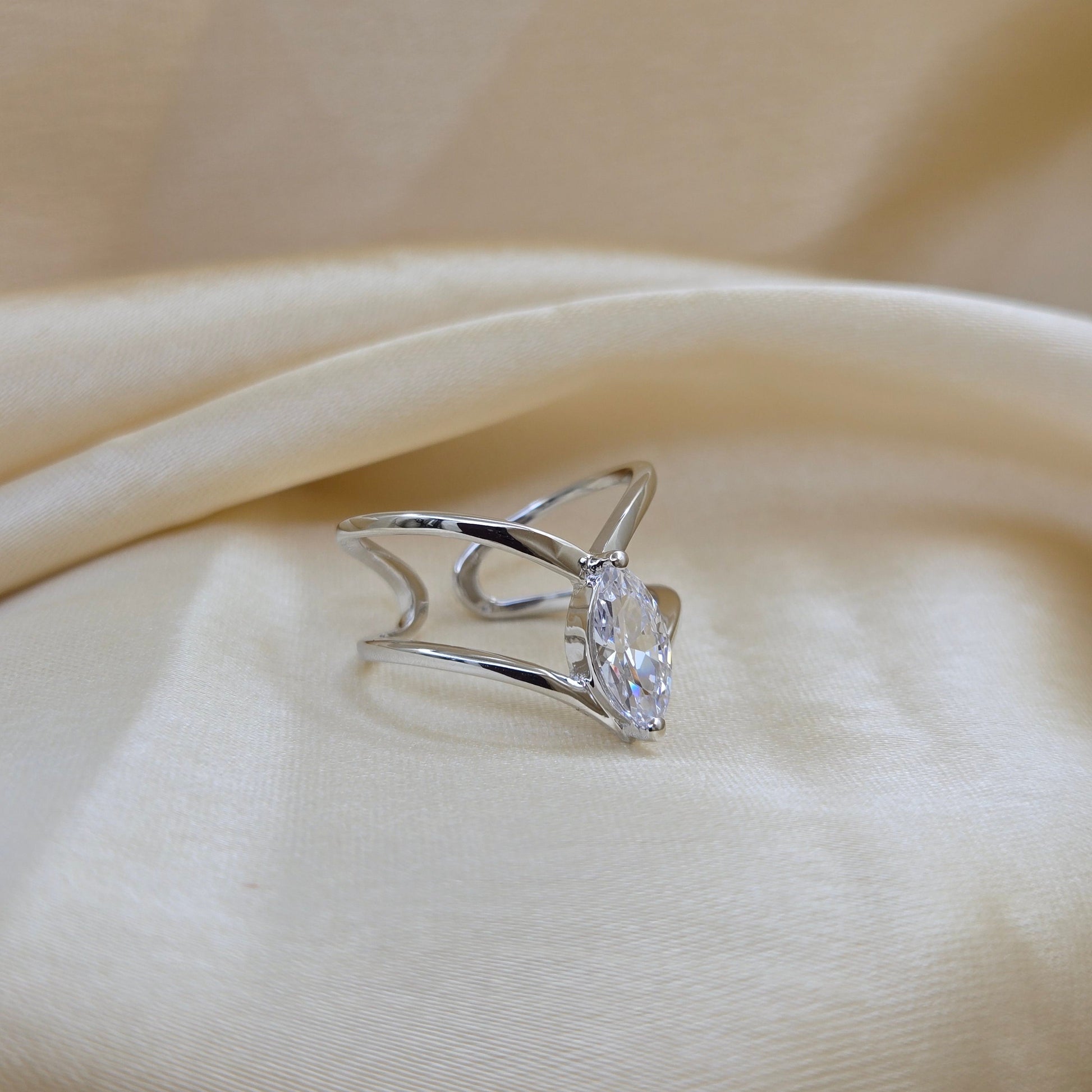 Rhodium-plated open band ring with a modern double-band design, featuring a marquise-cut clear zircon stone at the center offering refined sophistication for daily wear or special occasions.
